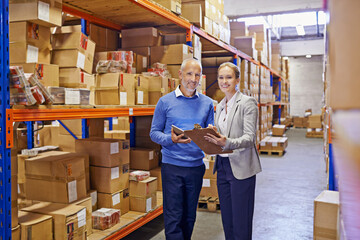 Portrait, boxes and man with woman, clipboard and documents with shipping form and import. Tablet, warehouse and export with teamwork or supply chain with stock or logistics with storage or industry