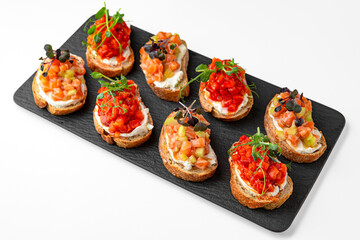 Bruschettas with salmon and tomato. Banquet festive dishes. Gourmet restaurant menu. White background.