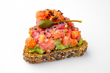 Tender bruschettas with salmon, guacamole and capers. Banquet festive dishes. Gourmet restaurant menu. White background.