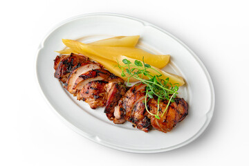 Grilled chicken fillet with baked pear on a white plate. Banquet festive dishes. Gourmet restaurant menu. White background.