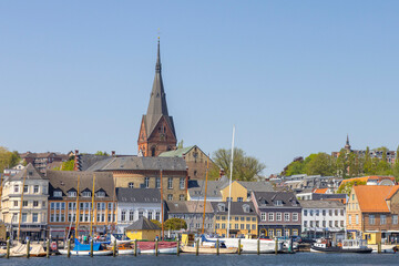 Obraz premium Happy walking along in Flensburg street (harbor) with old boats, Flensburg, Germany