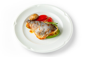 Dorado fish fillet baked with vegetables on a white plate. Banquet festive dishes. Gourmet restaurant menu. White background.