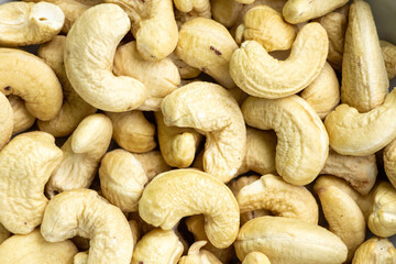 Delicious cashew nuts background. In the Bengali language, it is called Kaju Badam. Its scientific...