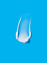 Face or body white cream, smear on colorful background