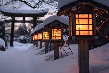 Fototapeten line of lanterns leading to a snowcovered torii gate, evening light © primopiano