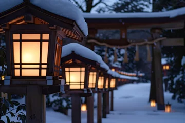 Poster line of lanterns leading to a snowcovered torii gate, evening light © primopiano