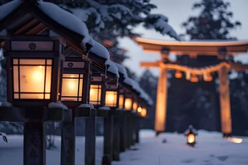 Poster line of lanterns leading to a snowcovered torii gate, evening light © primopiano