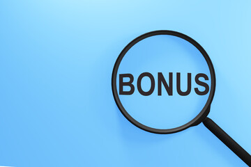 On a blue background a magnifying glass with the text BONUS. Business concept