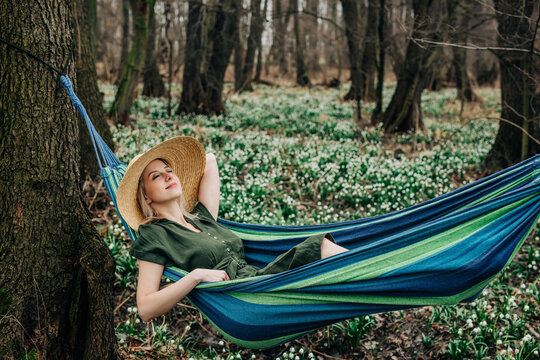 Carefree woman relaxing in hammock at forest