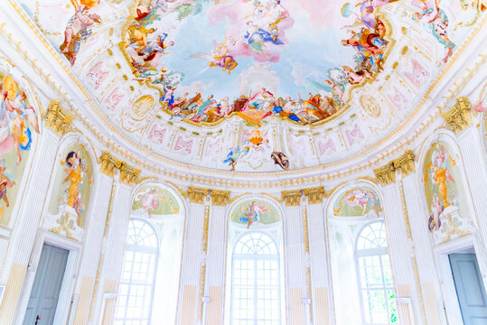 The Baroque Pavilion at Melk Abbey showcases a lavish frescoed ceiling with vibrant colors, intricate detail, and grandeur that captivates the eye.