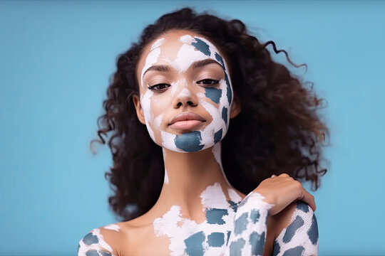 A woman with intricate white and blue paint designs on her face, creating a striking visual effect