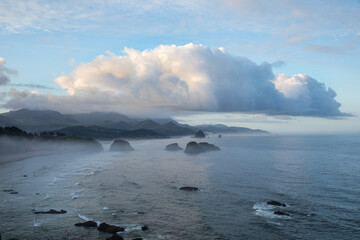 Beautiful colorful sunrise above famous Cannon Beach and Haystack Rock in Oregon, captured from Ecola Stat Park