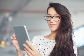 Fototapeta premium Tablet, glasses and portrait of business woman for online research, website news and internet. Office, creative startup and person on digital tech for networking, typing email and communication