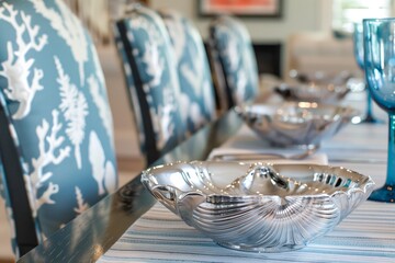 elegant table with silver shell bowls, coralprint chair covers, and blue stemware - obrazy, fototapety, plakaty