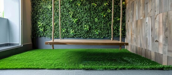 Indoor artificial grass beneath suspended wooden swing.