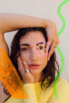 Young woman with doodles near face against white background