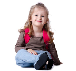Girl child with backpack sitting looking smiling on white background isolation. Childhood, education, products children