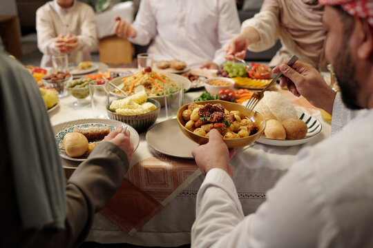 Unrecognizable Muslim Family Having Dinner