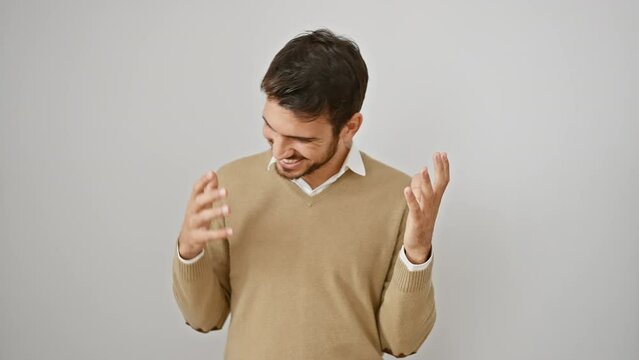 Ecstatic young hispanic man in sweater, arms magnificently raised, celebrating a crazy mad success win, engulfed in pure triumph, isolated against a clean white background!