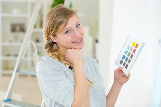young woman picking her color of the wall