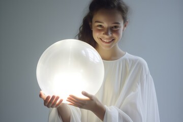 Cute woman with LED round flash lamp in white glow. Moon lamp turn on and hold by two hands. Generative AI.