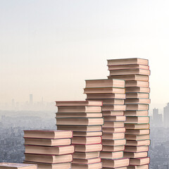 Stacked books with cityscape background - 769571583