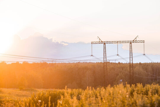 Power Transmission Lines (power Lines) On Steel Supports Against The Background Of The Evening Sunset Sky.