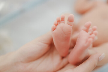 Tender Newborn Toes.  A heartwarming close-up of a parent cradling their baby’s delicate feet, radiating love and connection