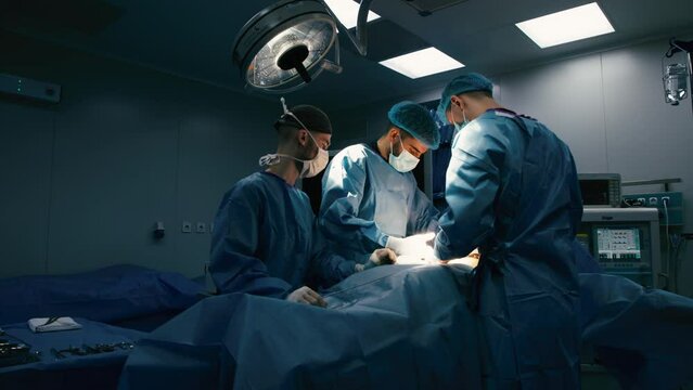 A group of professional surgeons in the operating room. Close-up of a surgical operation. Plastic surgery. Health. Surgery in a private clinic. Beauty and health.