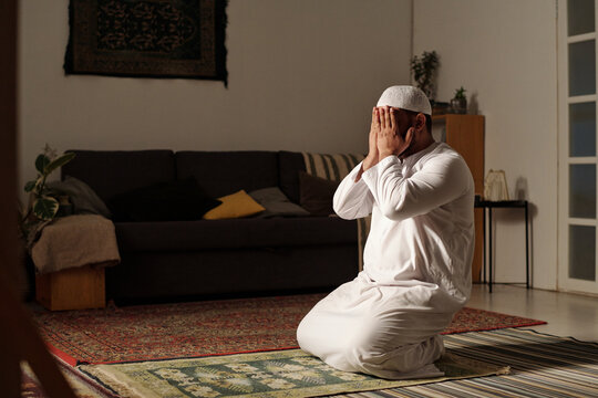 Unrecognizable Muslim Man Praying Salah At Home