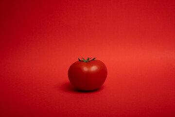 red tomato on a red background