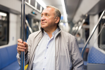 Fototapeta na wymiar Pensioner 60 year old rides in an subway car