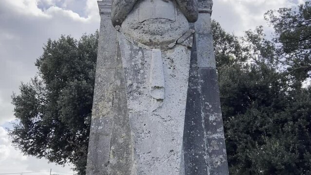 Mammalocchi statue travertine columns with allegorical figures standing at entrance to private villa in Umbria, Italy. Tilt-down