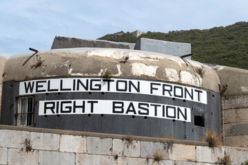 Low angle view of the Wellington Front Right Bastion casemates at Gibraltar, against a clear blue sky.