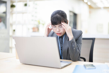 Fototapeta premium Tired office worker resting with eyes closed