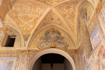 Cloister Santa Chiara, view of  corridor under arcades and decorated colorful frescoes, Naples,...