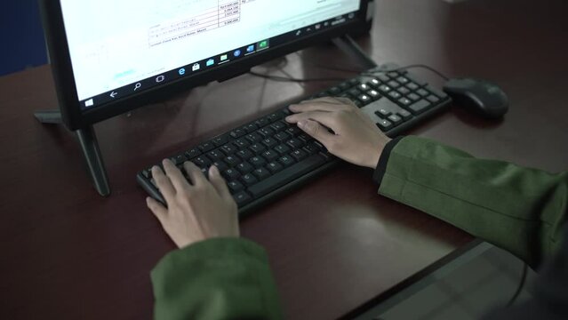 Students study computers in the computer lab wearing hijab. Muslim students