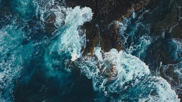 Waves splashing against the cliff aerial shot