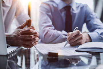 Obraz premium Teamwork read contract for accounting strategy, planning or company portfolio review.