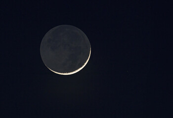 New moon with earthshine taken March 11, 2024 over Ottawa, Canada