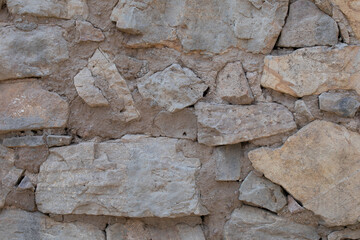 Rustic wall made of stones and cement