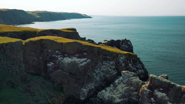 Aerial Flyover of St Abbs Head's Coastline Beauty and Nature Reserve in Scotland, United Kingdom.