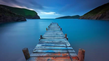  wooden jetty extending into the serene waters of the Lake District, with distant mountains © jiawei