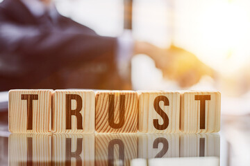 Wooden blocks with the word Trust. Trust relationships between business partners, friends,...