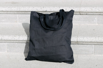 Black tote bag or eco cotton bag on stairs