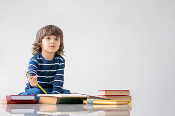 Education and back to school concept. Portrait of Happy little child boy learning to drawing and coloring on a book. Preschool children kids enjoy and fun study and doing homework at home.