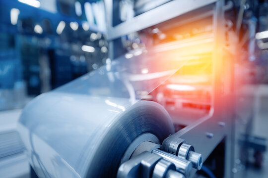 Operation of automatic machine plastic form for kit medical production. Closeup of roller blue toning, with sun lighting effect