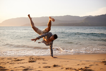 Man, dancer and breakdance with sand on beach for hip hop performance, workout training or...