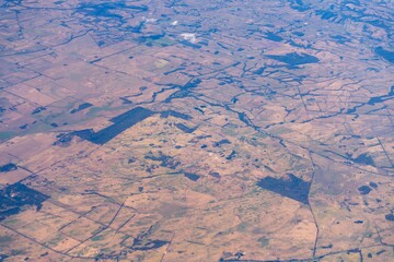 looking out plane window at eh clouds above australia in summer