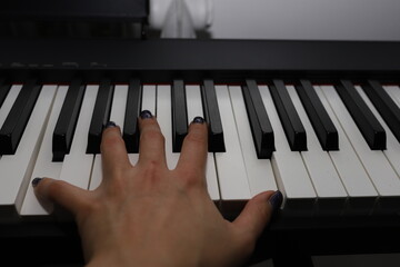 Musical education. The hand on the piano strikes a chord. Octaves of the piano.